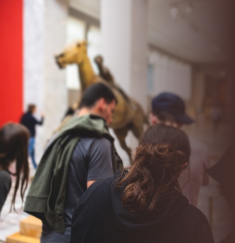 Parent and child viewing a large taxidermy animal display